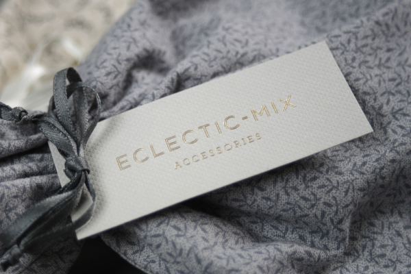 Tag with embossed surface and gold foil detail by Because Studio for fashion accessory label Eclectic-Mix