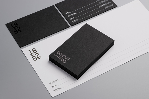 Logo and business card with black card and white and black foil detail designed by Pentagram for contemporary bone china designer Emily Johnson
