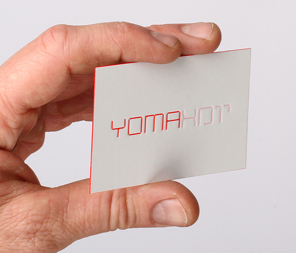 Logo and debossed business card with red edge painted detail designed by Kobi Benezri for Jerusalem-based architecture practice Yoma