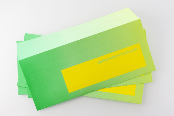 Logo and envelopes with fluorescent yellow and green print treatment created by Blok for Canadian charity Partners For Mental Health