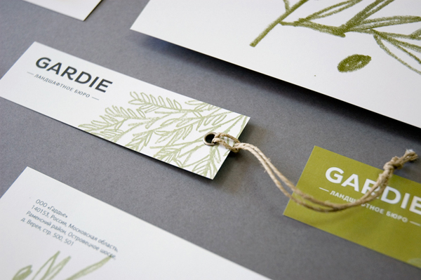 Logo, tag and stationery with hand drawn coloured pencil plant illustrations by Paradox Box for landscaping business Gardie