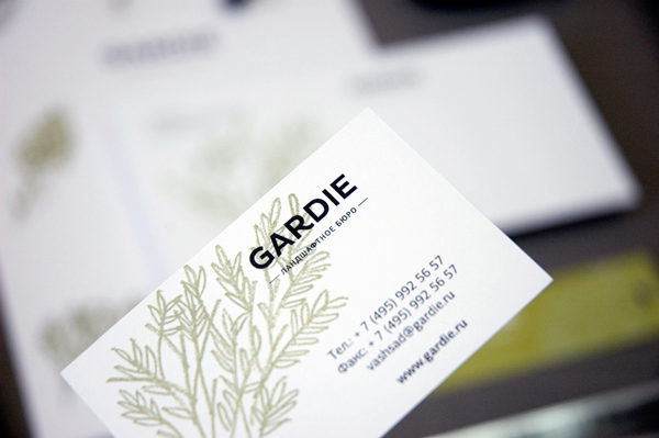 Logo and business card with hand drawn coloured pencil plant illustrations by Paradox Box for landscaping business Gardie