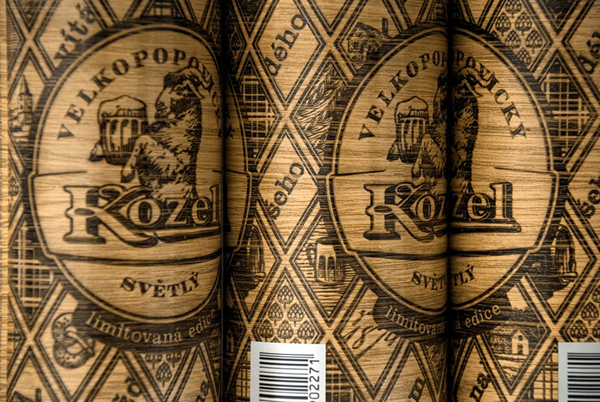 Packaging with heat treated wood effect and regional illustrations designed by Yurko Gutsulyak for Czech brewer Velkopopovický Kozel