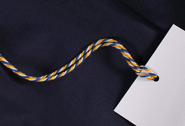 Tag with three colour cord for London and Paris-based male fashion brand Smith-Wykes designed by Studio Small