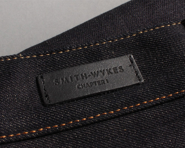 Logo and stitched leather clothing label for London and Paris-based male fashion brand Smith-Wykes designed by Studio Small