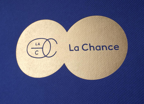 Gold foil logo across a blue embossed surface treatment for furniture and lighting company La Chance designed by Artworklove