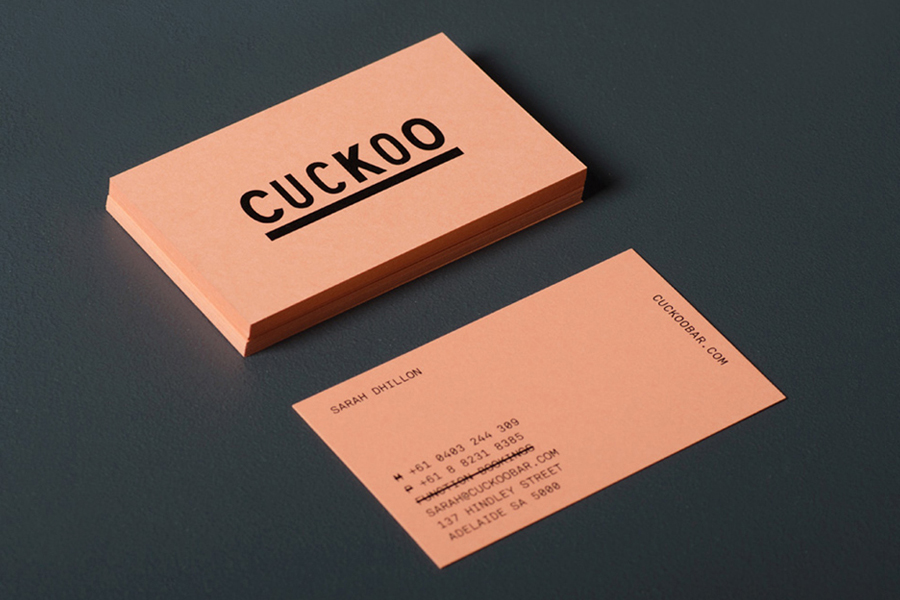 Logo and salmon pink business card designed by Band for underground electronic music venue, cocktail and tapas bar Cuckoo