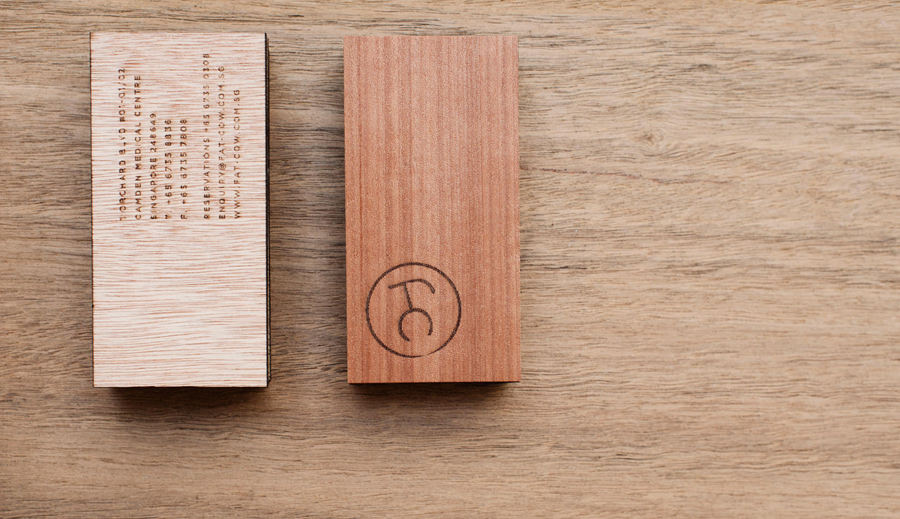 Logo and wood business card with heat stamp treatment for specialist beef restaurant Fat Cow designed by Foreign Policy