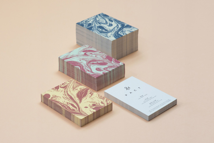 Logo and business card with marble pattern designed by Acre for co-branded retail partnership Pact