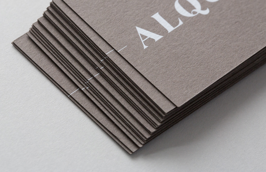 Logotype and white ink, warm grey business card designed by ThoughtAssembly for quarterly beverage magazine Alquimie