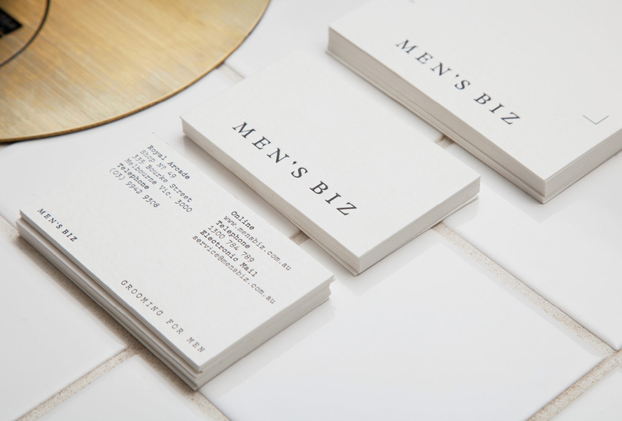 Logotype, letterpress business cards and acid-etched brass signage by ThoughtAssembly for male grooming business Men's Biz