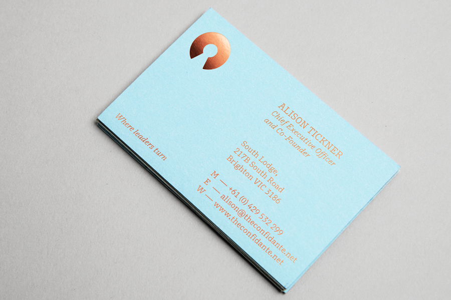 Logo and blue copper foiled business card designed by Re for executive coaching and mentoring service The Confidante