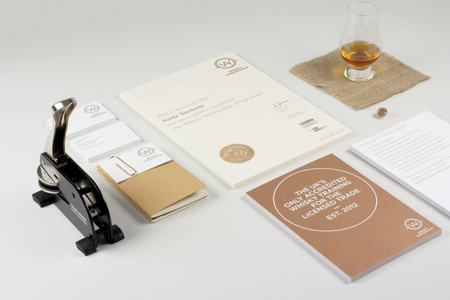 Logo and print with copper print and blind emboss details designed by O Street for Whisky Ambassador