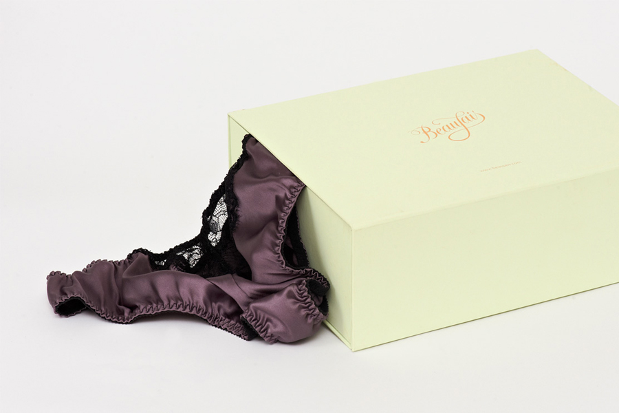 Packaging with gold foil print finish and mint paper designed by Parent for luxury lingerie brand Beaujais