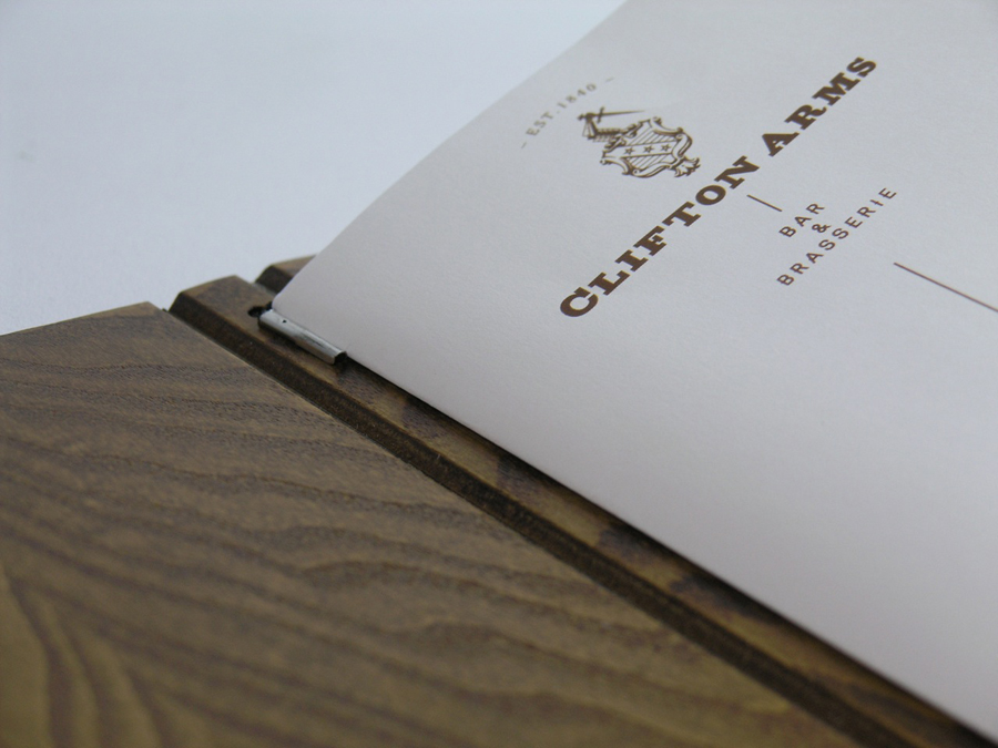 Wooden menu cover and interior pages with copper ink print treatment designed by Wash for the Clifton Arms Hotel