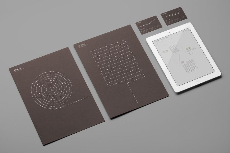 Logo and business card with brown board and silver foil detail designed by Mucho for Spanish leadership consultancy Coma