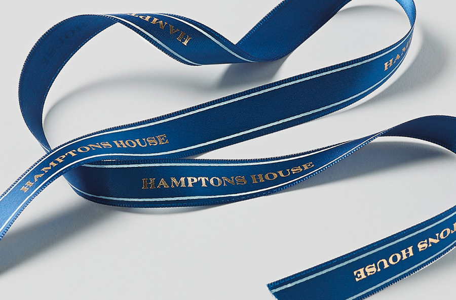 Logo and ribbon with gold detail designed by Moffitt.Moffitt for Sydney furniture and homeware retailer Hamptons House