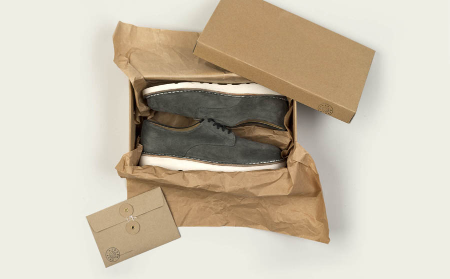 Box with uncoated, unbleached material and stamp detail created by Bielke+Yang for Norwegian shoe brand Deep Search