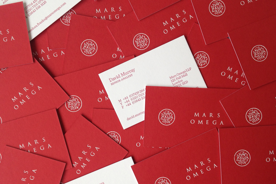Logo and letter-pressed business cards with white foil detail for London-based information gathering consultancy Mars Omega designed by Igloo