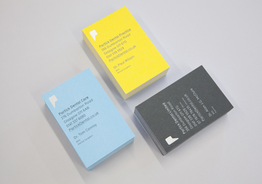 Logo and business cards with yellow blue and grey board detail designed by Freytag Anderson for Partick Dental featured on BPO