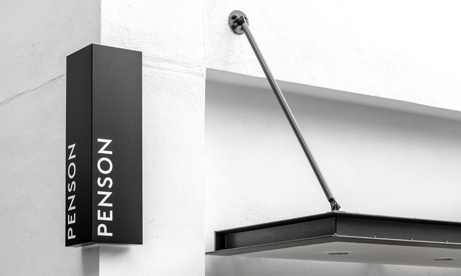 Logotype and exterior signage for interior design firm Penson Group created by She Was Only