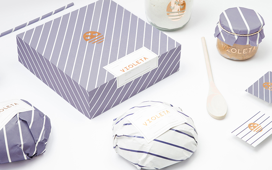 Logo and packaging with copper foil detail designed by Anagrama for traditional Argentinian bakery Voleta