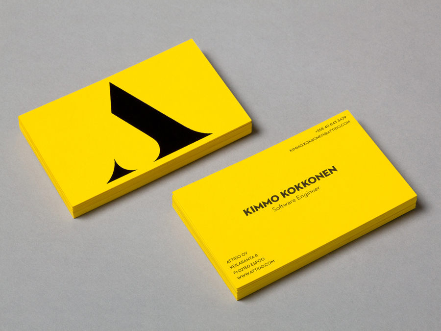 Logo and business card with a yellow board and black ink colour palette designed by Bond for Finnish information system development and optimisation company Attido