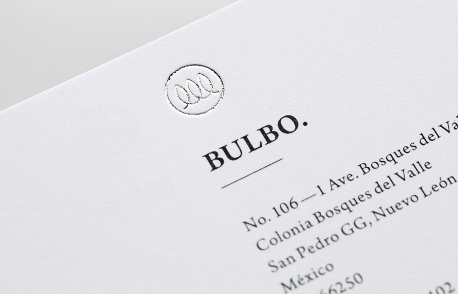 Logo and business card with silver foil detail for high-end boutique lighting shop and interior planning service Bulbo designed by Anagrama