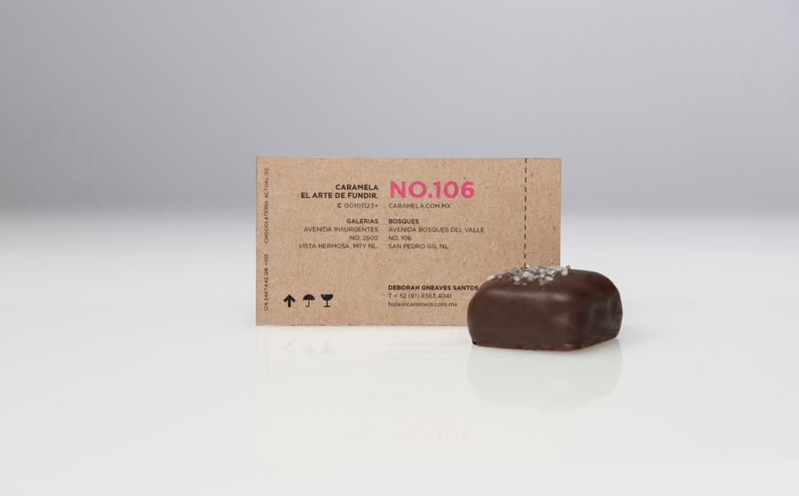 Business card with pink neon ink across an unbleached substrate designed by Anagrama for chocolate boutique and caterer Caramela