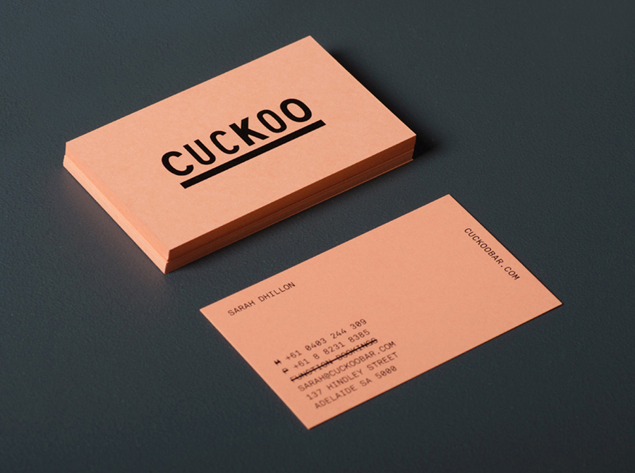 Logo and salmon pink business card designed by Band for underground electronic music venue, cocktail and tapas bar Cuckoo
