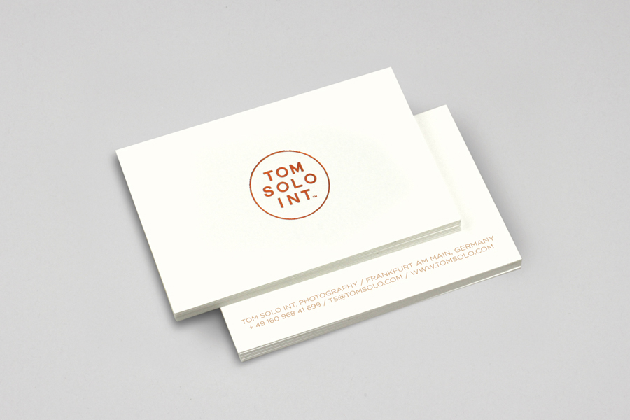 Logo and business card with debossed copper foil detail for photographer Tom Solo designed by Mash