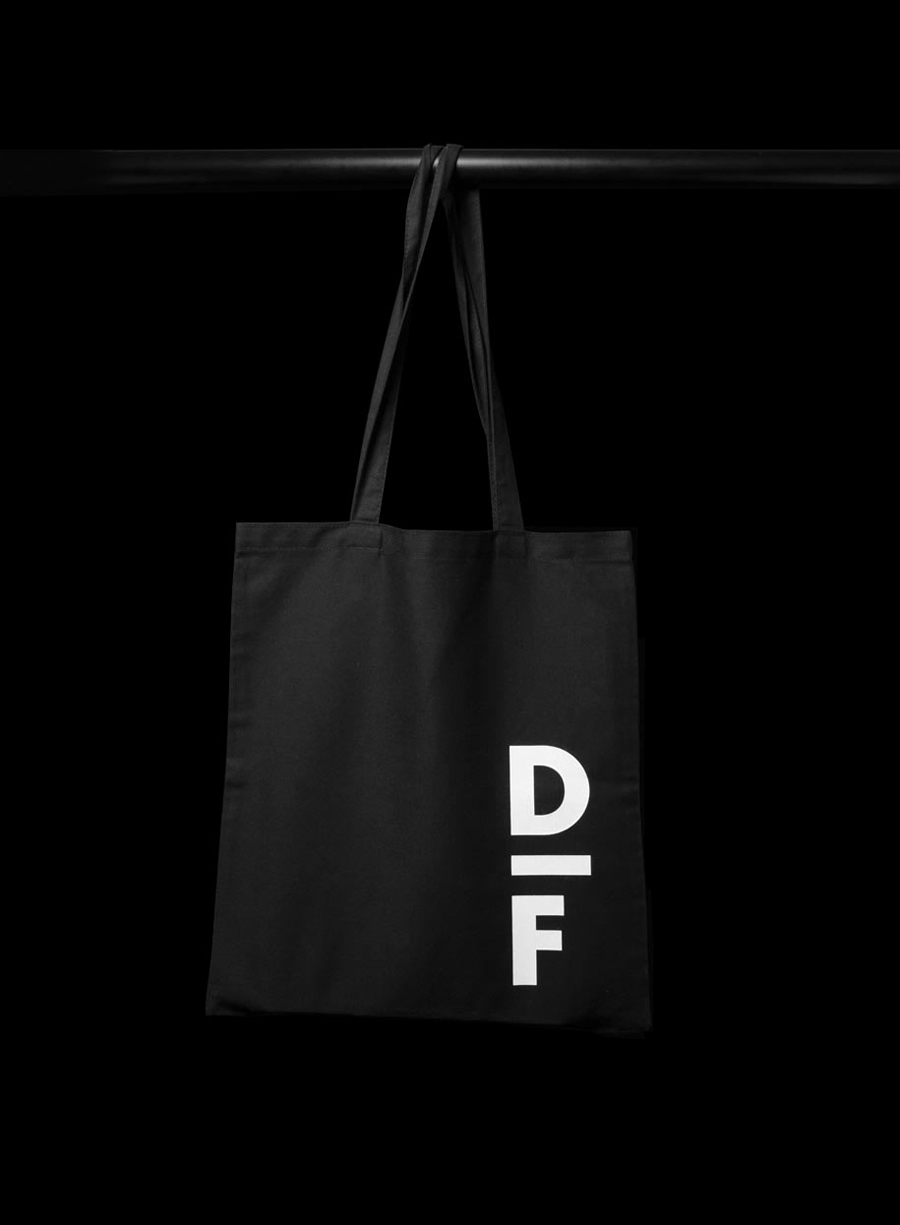 Logo and tote bag with white ink detail created by Spin for creative exchange and artistic development network Delfina Foundation