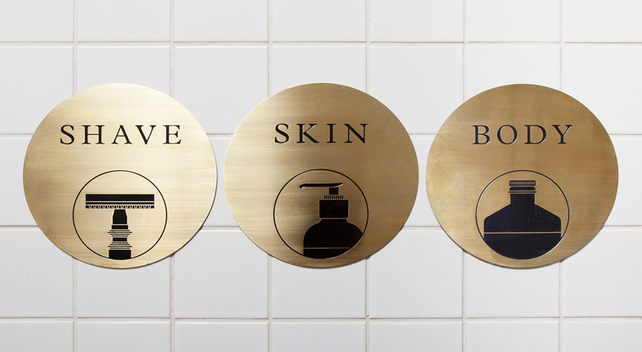 Acid-etched brass signage by ThoughtAssembly for male grooming business Men's Biz