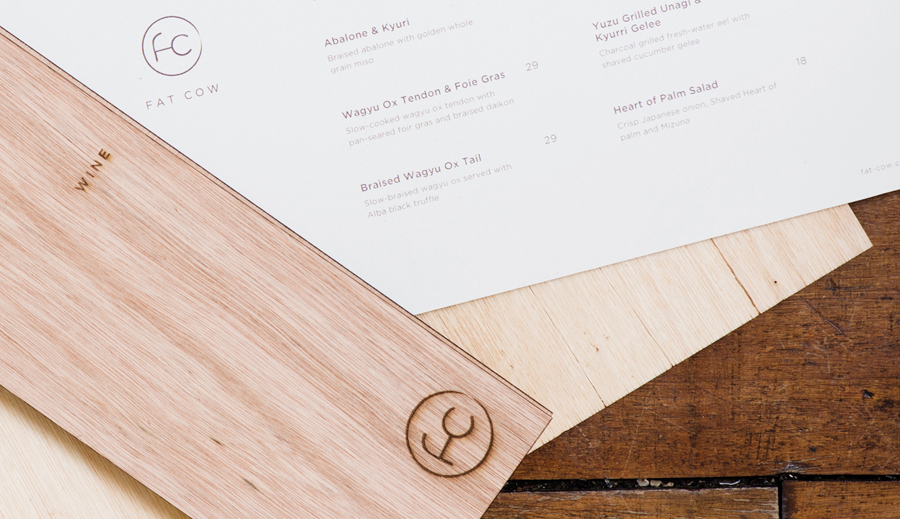 Logo and wood menu covers with heat treated detail for specialist beef restaurant Fat Cow designed by Foreign Policy