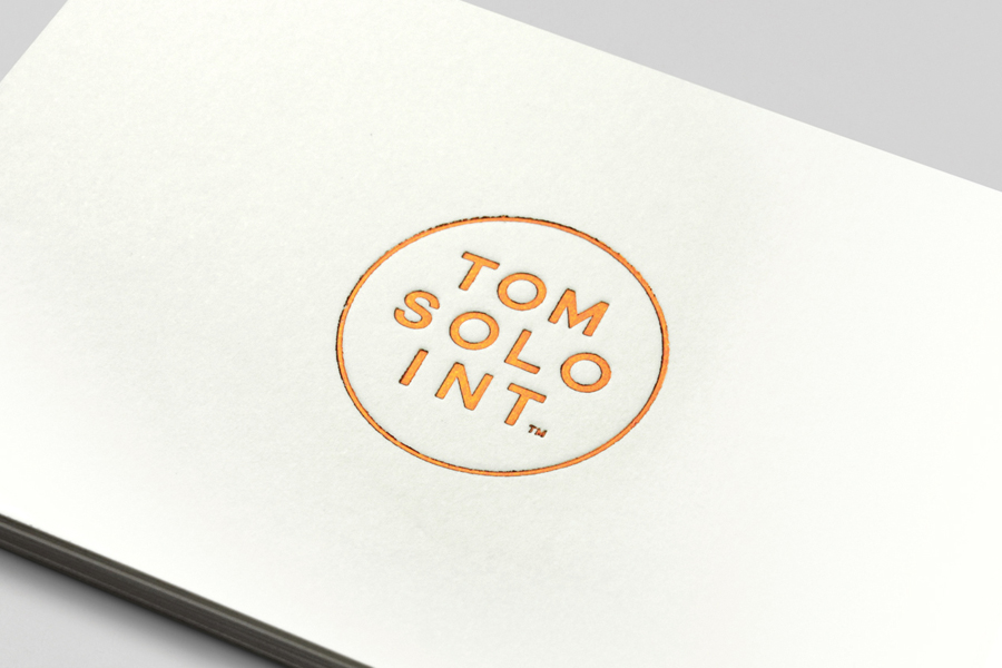 Logo and business card with debossed copper foil detail for photographer Tom Solo designed by Mash