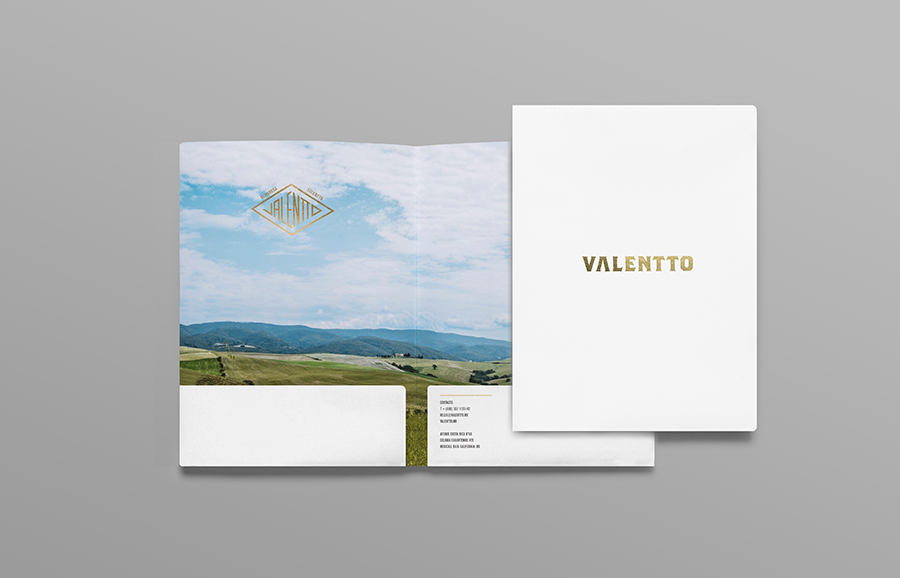 Logo and folder with gold foil and photographic landscape detail designed by Anagrama for olive oil brand Valentto