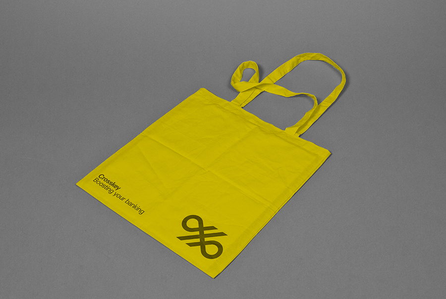 Logo and yellow tote bag for banking systems and solutions firm Crosskey designed by Kurppa Hosk