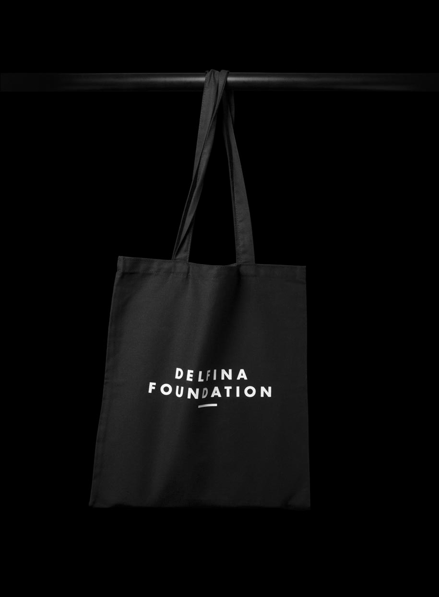 Logo and tote bag with white ink detail created by Spin for creative exchange and artistic development network Delfina Foundation
