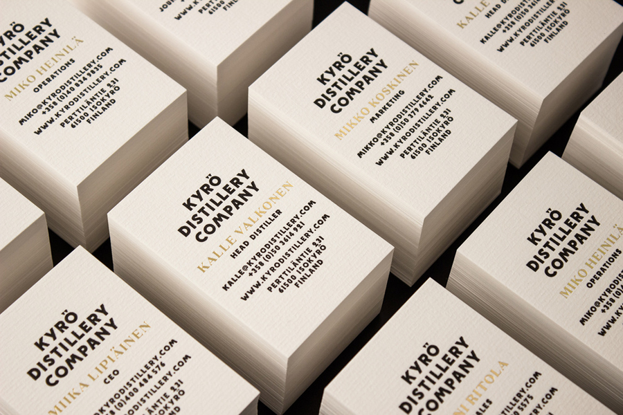 Business cards with laid paper and gold foil detail designed by Werklig for Kyrö Distillery Company