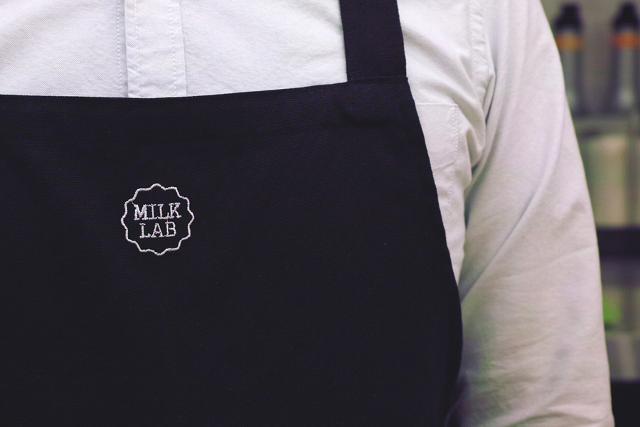 Milk Lab pinny with stitched logo detail designed by Studio FNT