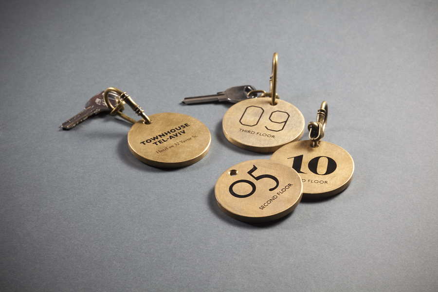Logo and bronze keychains with mixed typographic detail for Tel Aviv hotel Townhouse designed by Koniak