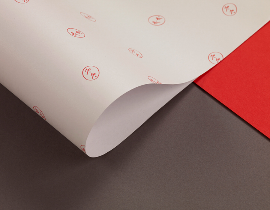 Print with a red spot colour monogram detail designed by ico for jewellery brand Mark Milton