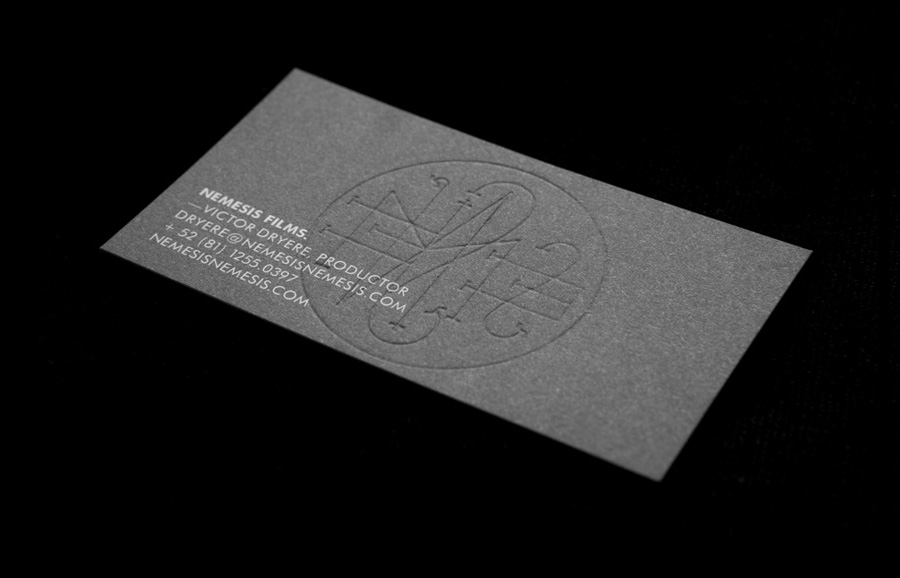 Logo and business card with a black board, white ink and blind embossed detail designed by Anagrama for Latin American horror film production company Nemesis Films