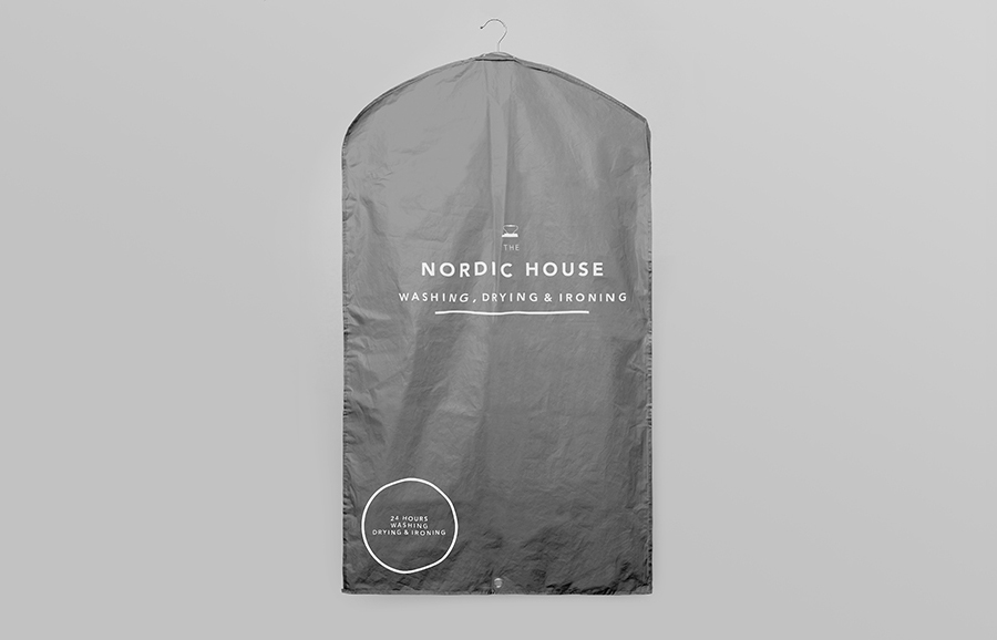 Logo and clothes cover designed by Anagrama for dry cleaning shop Nordic House