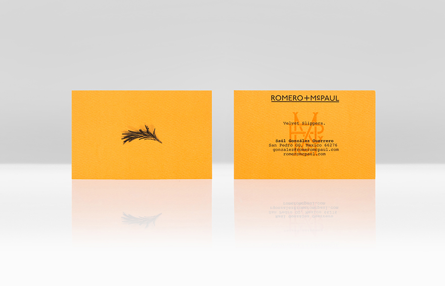 Logo and orange business card with an embossed surface finish created by Anagrama for luxury slipper brand Romero+McPaul