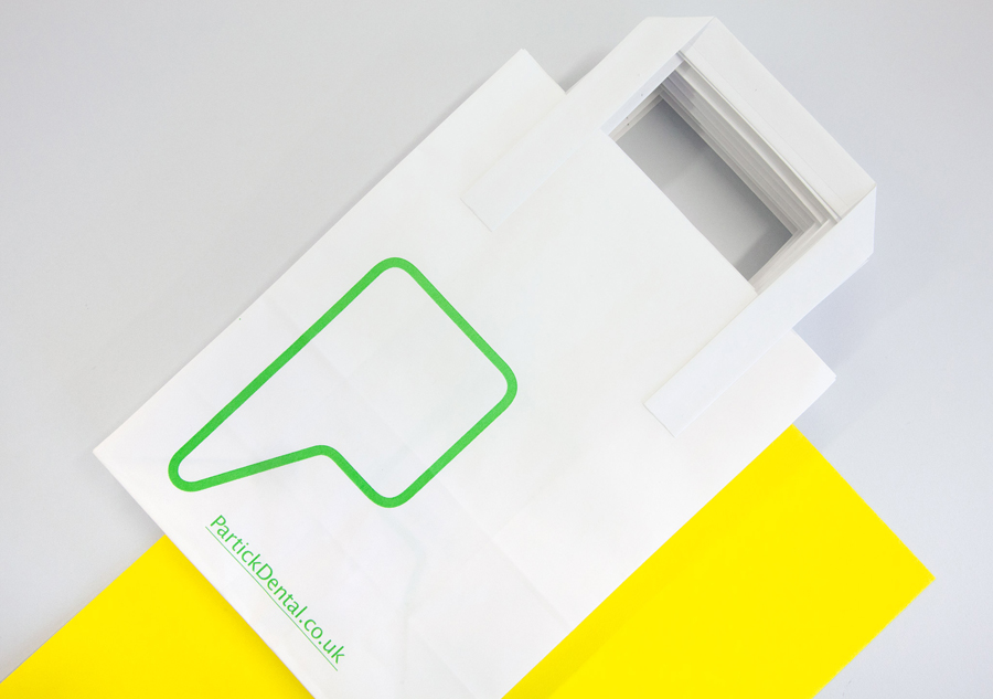 Logo and print with yellow paper and fluorescent green print finish designed by Freytag Anderson for Partick Dental featured on BPO