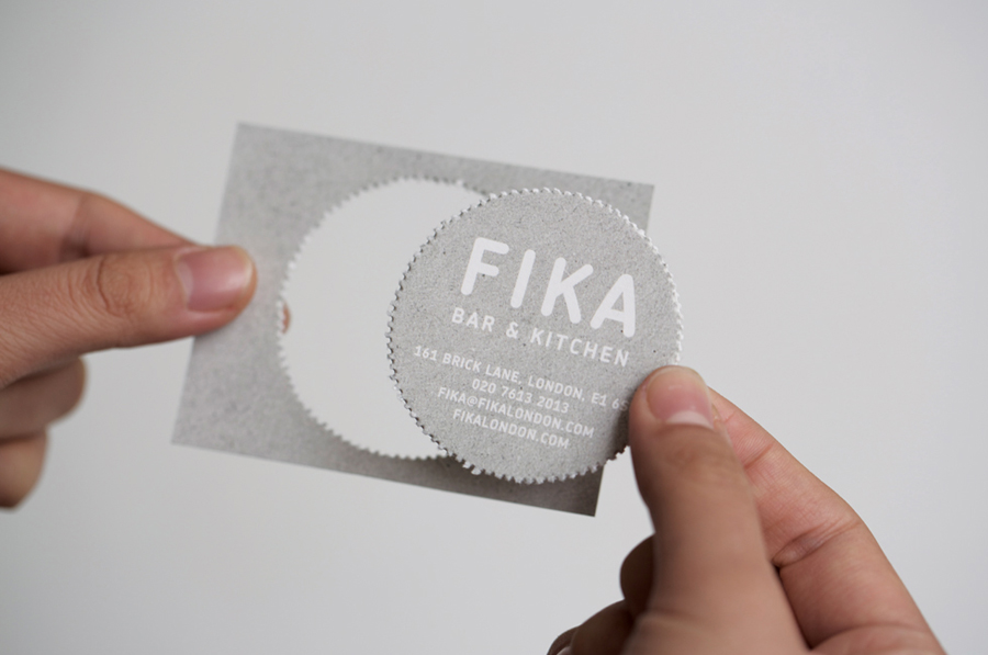 Business card with white ink, unbleached board, illustrated and perforated detail created by Designers Anonymous for London kitchen and bar Fika