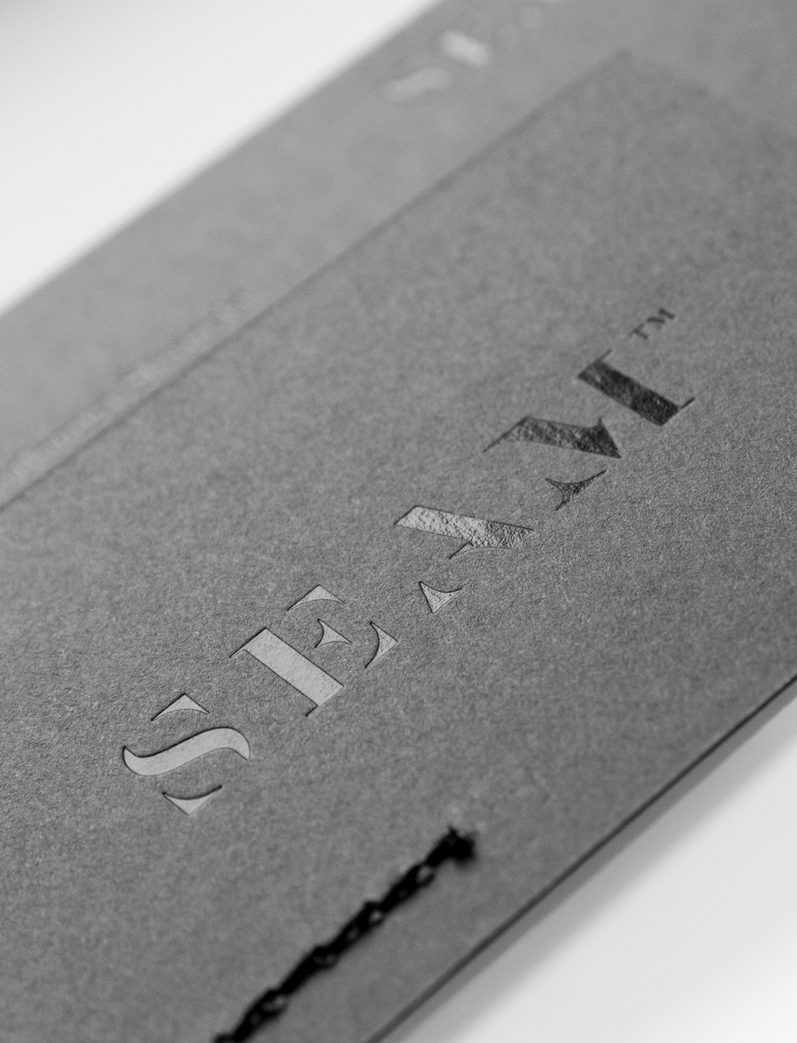 Logo and business card with black foil and stitch detail designed by For Brands for fashion brand Seam