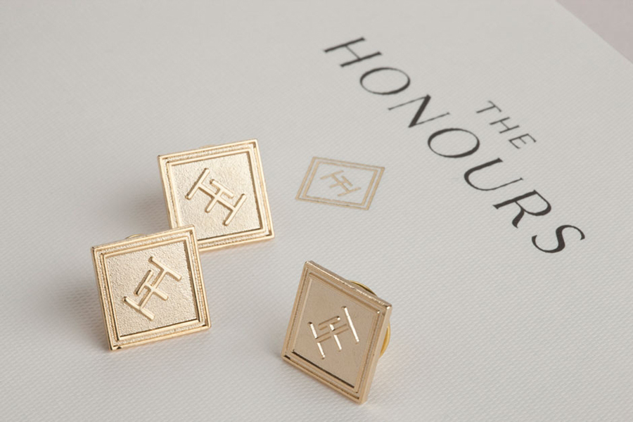 Logo and lapel pins for brasserie The Honours designed by Touch