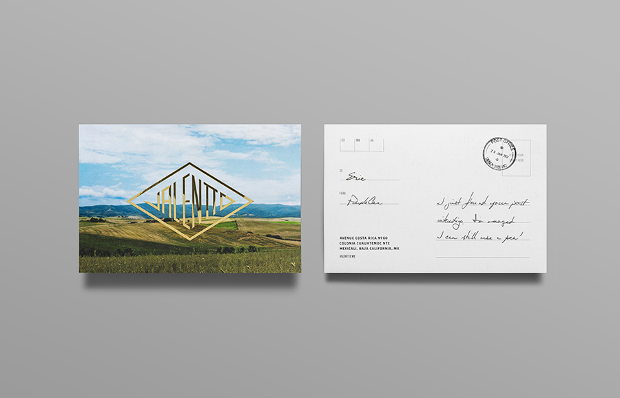 Logo and postcard with gold foil, photographic landscape and stamp detail designed by Anagrama for olive oil brand Valentto